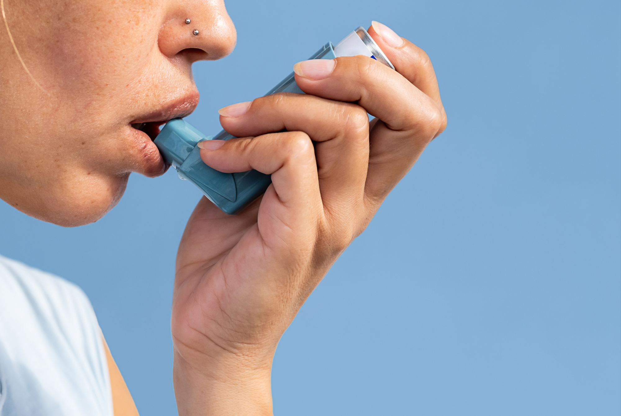 Person using an asthma inhaler