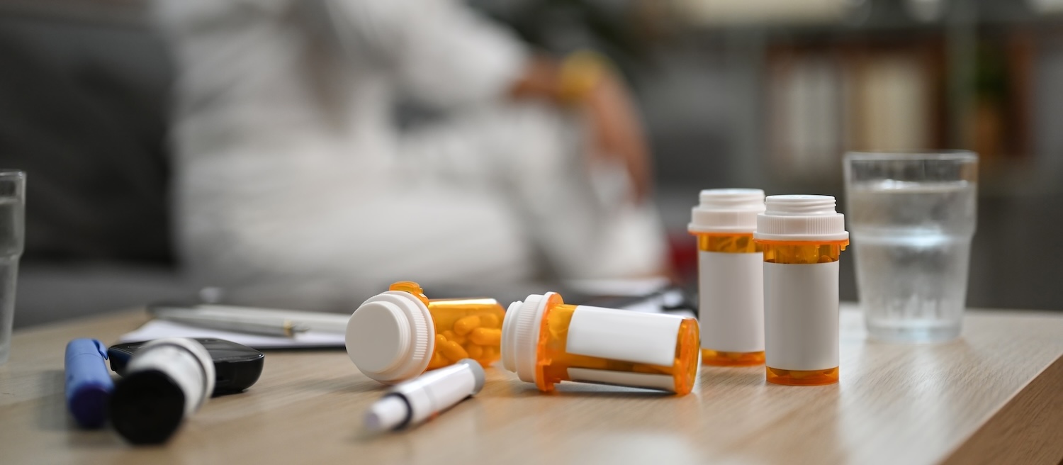 Allergy medication bottle and pills